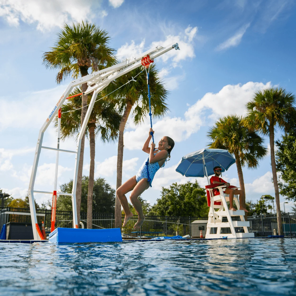 Child riding an AquaZip'N water zip line